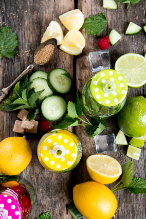 Mohito lime drinks on wooden with blur beach background. Fresh drinks with fruits on wood. Summer concept.の写真素材