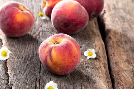 Fresh peaches on wooden tableの写真素材