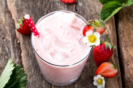 Fresh milk, strawberry on wooden table, assorted protein cocktail with fresh fruits.の写真素材