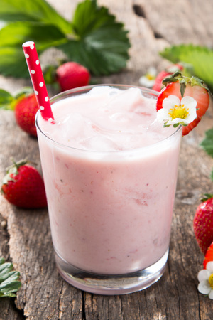 Fresh milk, strawberry on wooden table, assorted protein cocktail with fresh fruits.の写真素材