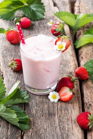 Fresh milk, strawberry on wooden table, assorted protein cocktail with fresh fruitsの写真素材