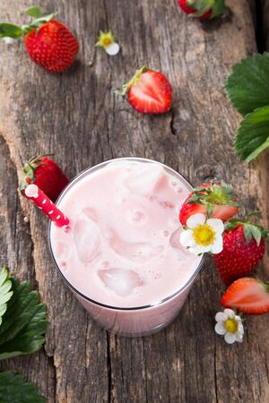 Fresh milk, strawberry on wooden table, assorted protein cocktail with fresh fruits.の写真素材