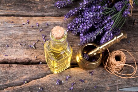 Spa massage setting, lavender product, oil on woodenの写真素材