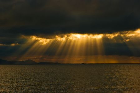 Seascape taken on the beach in Punta Ala (GR) immediately after a storm with sunbeams through dark...