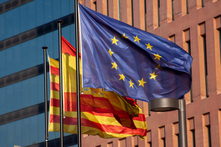 Flags arranged against a building, creating a layered composition. National and regional symbols, urban backdrop, and a sense of identity.の写真素材