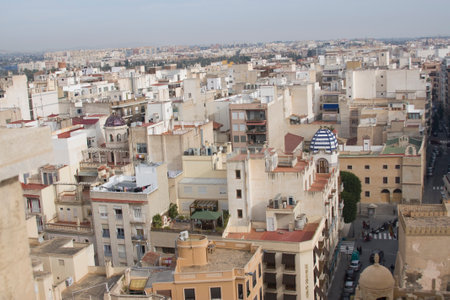Wide shot of a Spanish cityscape, emphasizing the vastness of the urban area. Buildings, rooftops, and a sense of urban sprawl.の写真素材