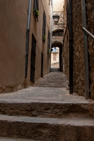 Aged alleyway with a stone stairway leading uphill. Architectural details, cobblestone steps, and perspectiveの写真素材