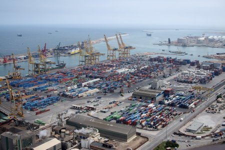 Busy port with stacked shipping containers and industrial equipment. High-angle view, maritime...