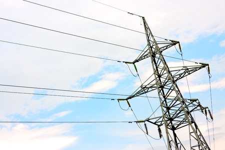 High voltage line tower against skyの写真素材
