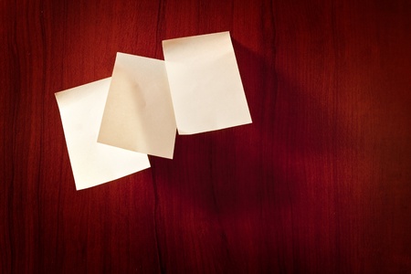 Three sticky paper reminder notes on brown wallの写真素材