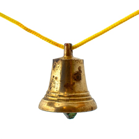 Old bronze bell on yellow ropeの写真素材