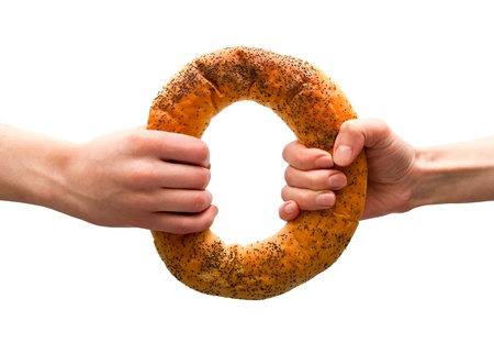 Hands holding ring bread isolated on white  Sharing conceptの写真素材