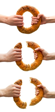 Set of hands breaking ring bread isolated on white  Sharing conceptの写真素材