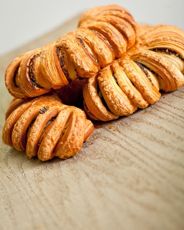 Crusty buns with poppy grains on a tableの写真素材