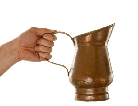Hand holding tin jug isolated over white backgroundの写真素材