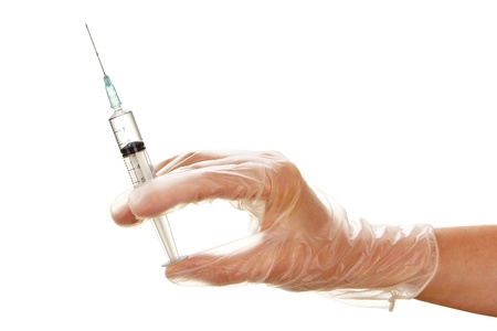 Woman's hand in disposable glove with syringe isolated on white backgroundの写真素材