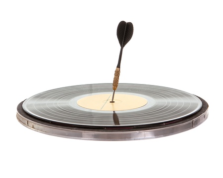 Dart arrow poked in a vinyl record isolated on white