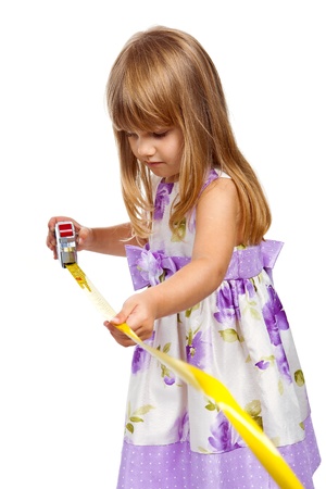 Little girl with measuring tape isolated on white backgroundの写真素材