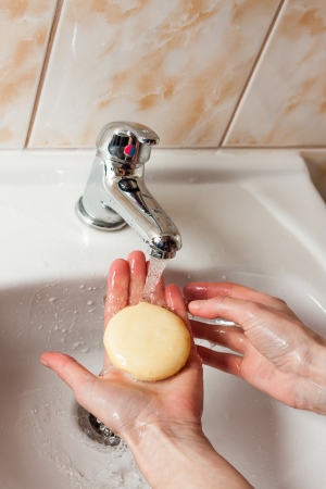 Washing hands with soap under water tapの写真素材