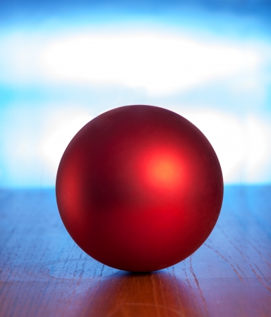 Red ball on table against blue backgroundの写真素材