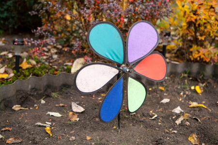 Toy windmill in the autumn gardenの写真素材