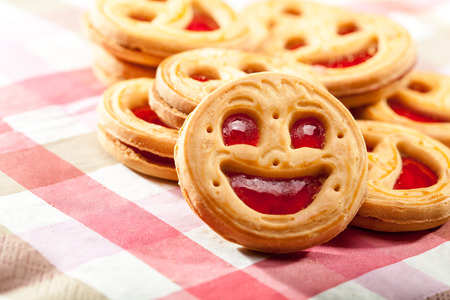 Smiling cookie face on a tableの写真素材