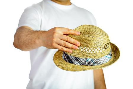 Straw hat hold by man over white backgroundの写真素材