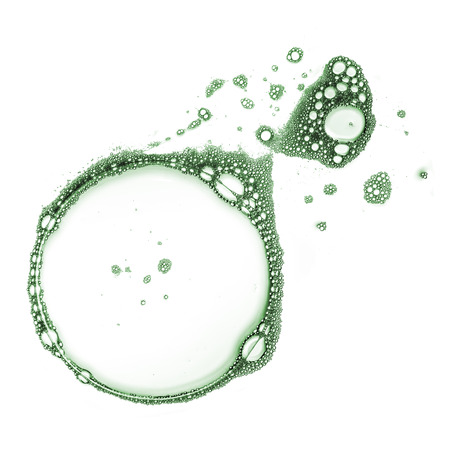 Green shampoo foam bubbles isolated over white backgroundの写真素材