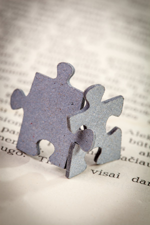 closeup of two jigsaw puzzle pieces on a page of  bookの写真素材