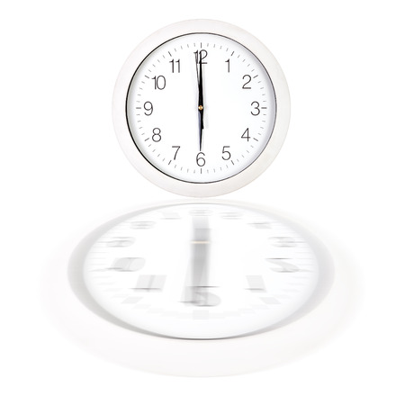 Clock face showing six o'clock over white background with reflection