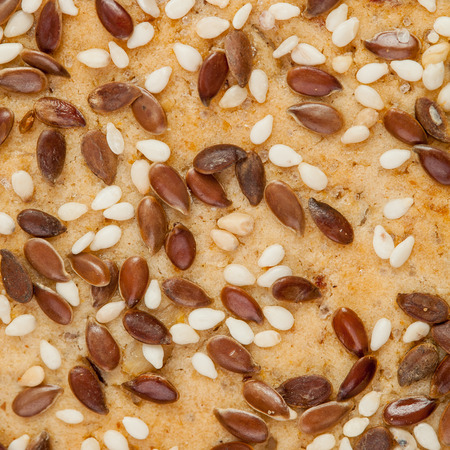 Macro of flax and sesame seeds on cookie surfaceの写真素材