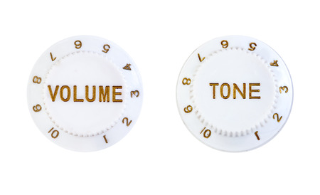 Close ups of volume and tone control buttons isolated over white background