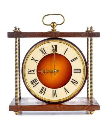 Old clock with roman numerals showing nine o'clock over white backgroundの写真素材
