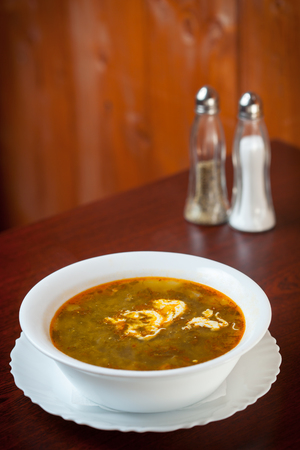 Sorrel soup bowl on brown tableの写真素材