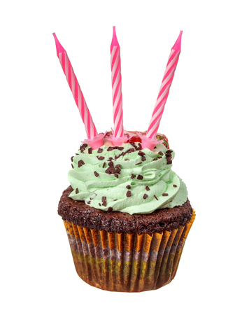Green cupcake with three red candles on top isolated on whiteの写真素材