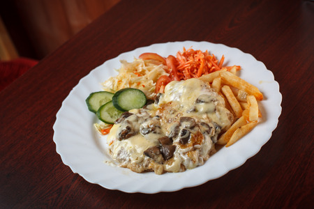 Plate of beef steak with cheese, mushrooms and vegetables の写真素材