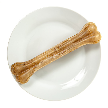 Dog bone on plate isolated over whiteの写真素材