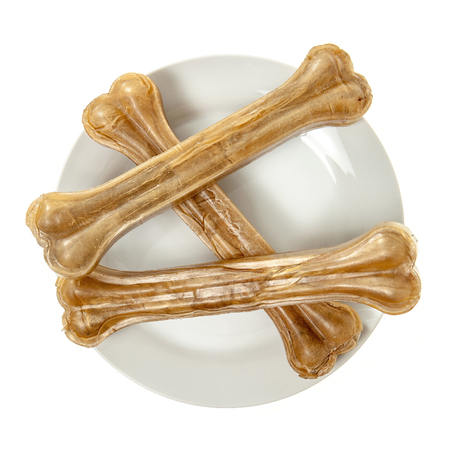 Three dog bones on food plate isolated over whiteの写真素材