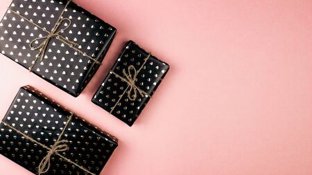 Gift boxes wrapped in hearts paper flat lay on pink background with copy space. 8 march, Mothers day, Valentines Day gifts top view. Celebrate concept. Template for web, social media. Stock photo.の写真素材