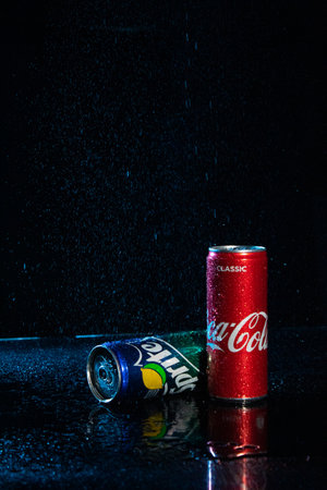 Coca cola and sprite soda cans with water drops on black background editorial stock photo. Pepsico brand company. Carbonated sweet soft drink. Pepsi logo. Illustrative materialのeditorial素材