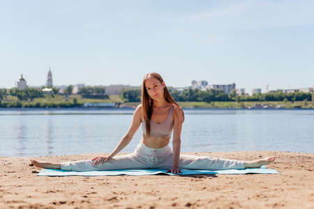 Middle aged woman in sportswear doing yoga exercise. Stretching woman outdoor. Bridge asana. meditation concept.の写真素材