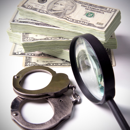Finance and Law, economic crime, the punishment of the offender, pack of dollars, steel handcuffs, square image, DSLR photography, finance and law, shadow capital, punishment crime.の写真素材