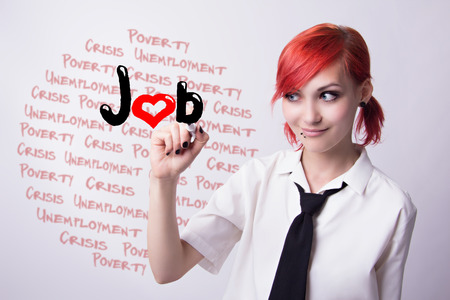 Red-haired girl, the threat of unemployment, piercings on his face, in search of work, earrings tunnels, he wrote marker, tie and white shirt, black manicure, student doing homework.の写真素材