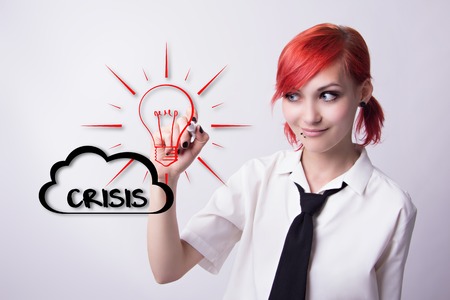 Red-haired girl, out of the crisis, the cloud that says, the idea of a light bulb, piercings on his face, earrings tunnels, he wrote marker, tie and white shirt, student doing homework.の写真素材
