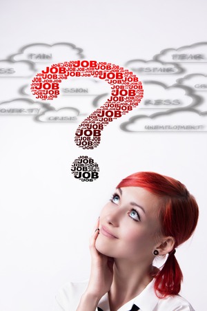 Red-haired girl, question mark built of text, search for work, onset of the crisis, the clouds with the words, the financial crisis, piercings on his face, vertical photo, tie and white shirt.の写真素材