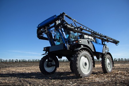Farming techniques, high tractor irrigation fields, agricultural industry, tractor working on the...