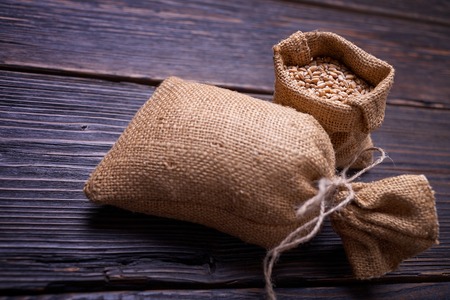 Fresh bread, baked goods, harvest on the farm, delicious food, burlap sack of grain, healthy food, a...