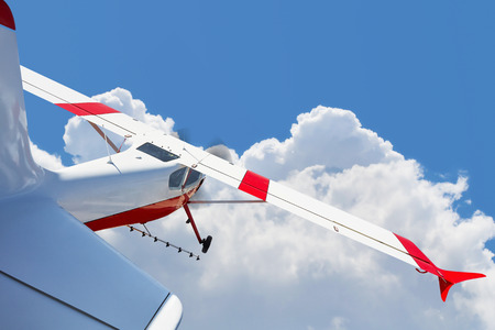 Aircraft spraying fields, light aircraft flying in the clouds, aviation, agriculture, cloudy sky.