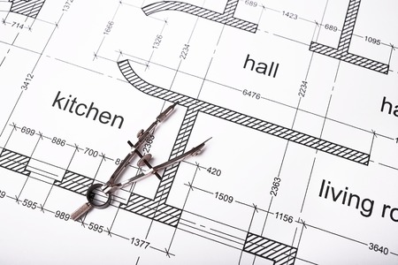 Construction of the building layout, building drawing on paper, steel compasses for drawing