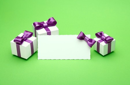Greeting card with a satin bow, gifts in a beautiful package, for writing greetings card, several boxes of presents, festive mood attributesの写真素材